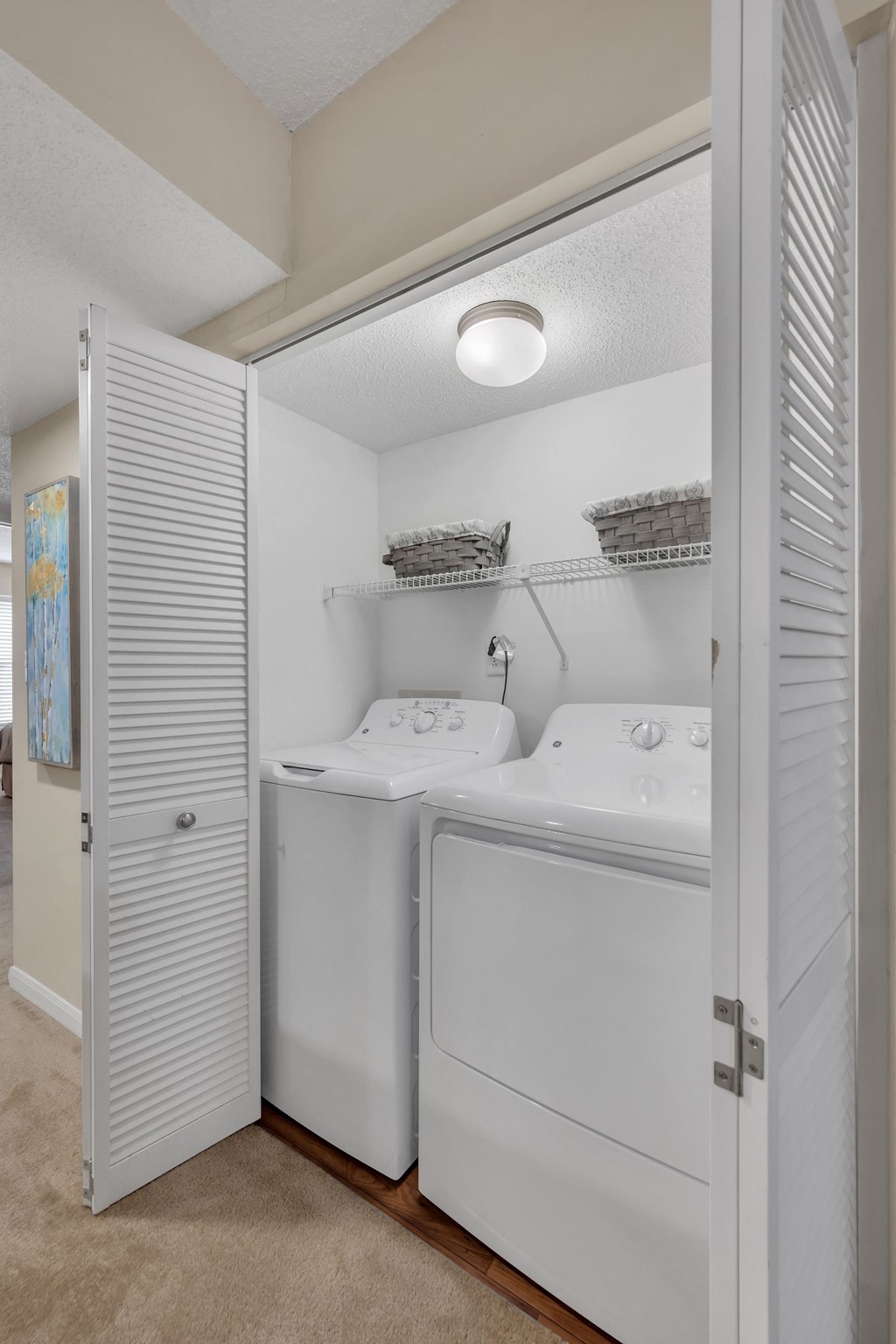 a laundry room with two sinks and a washer and dryer